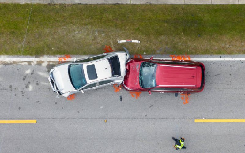 Car crash with two vehicles collided at traffic accident site on American street.